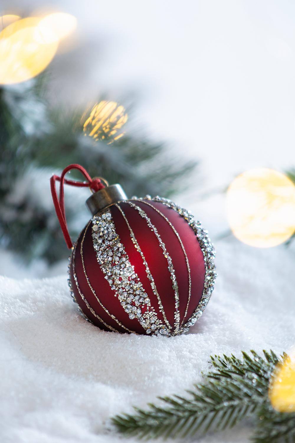 Red matte Christmas ornament with silver glitter stripes and crystal accents