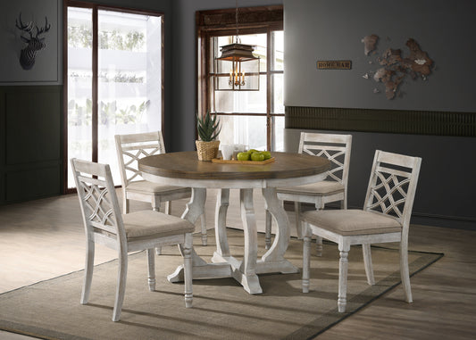 Distressed white wood dining chairs with upholstered seats arranged around round wood table