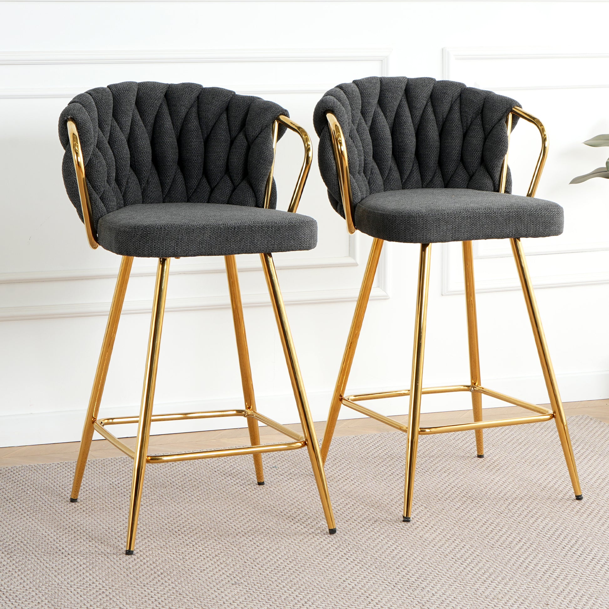 Dark gray tufted bar stools with gold legs perfect for modern kitchens
