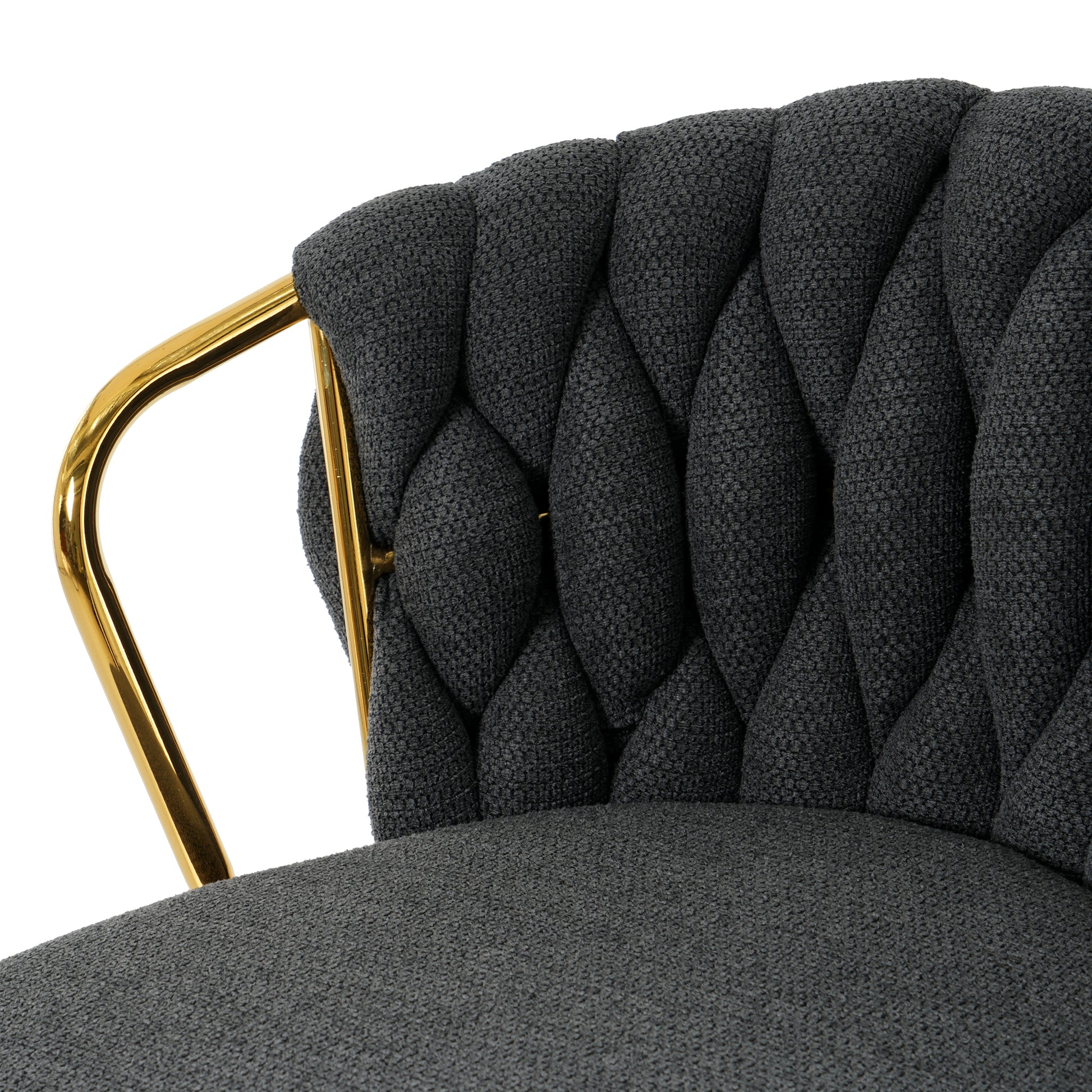 Dark gray upholstered accent chair with tufted back and gold metal legs