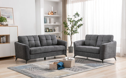 Dark gray upholstered loveseat with tufted cushions and modern black legs