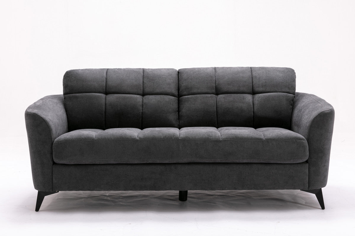 Dark gray tufted sofa with plush fabric and modern design
