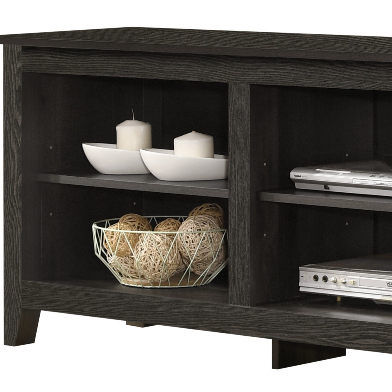 Dark wood media console with two shelves holding decorative items