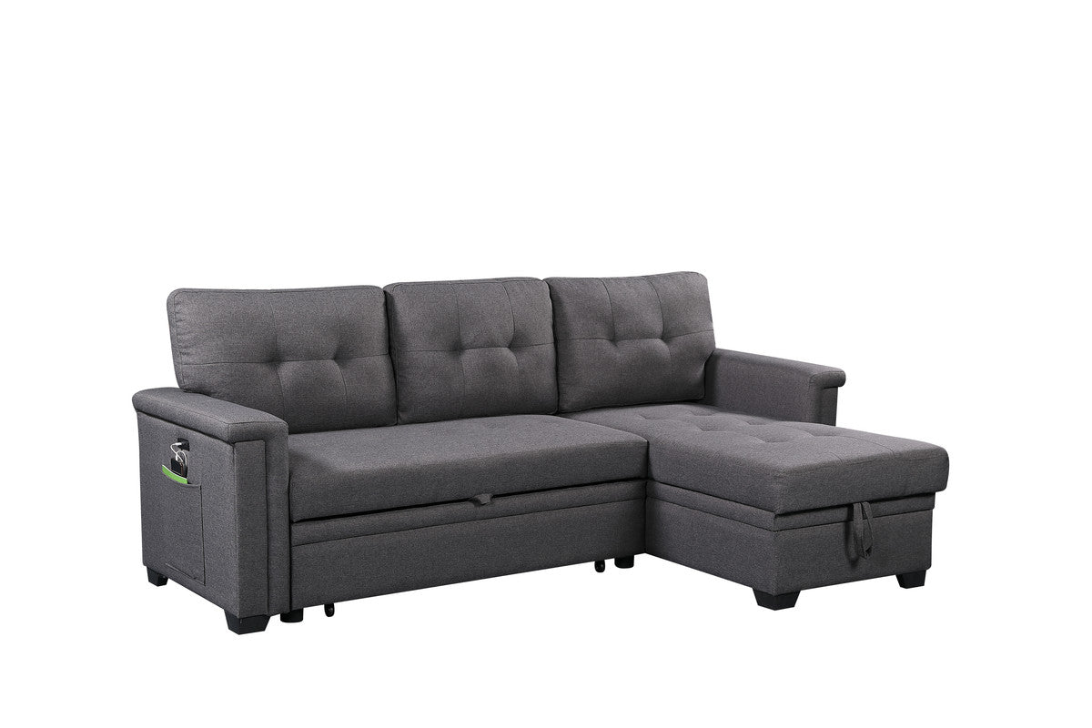 Dark grey upholstered sectional sofa with tufted cushions and storage chaise