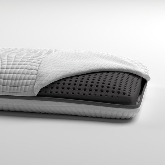 Cutaway view of a quilted white mattress cover revealing ventilated charcoal foam core for optimal airflow