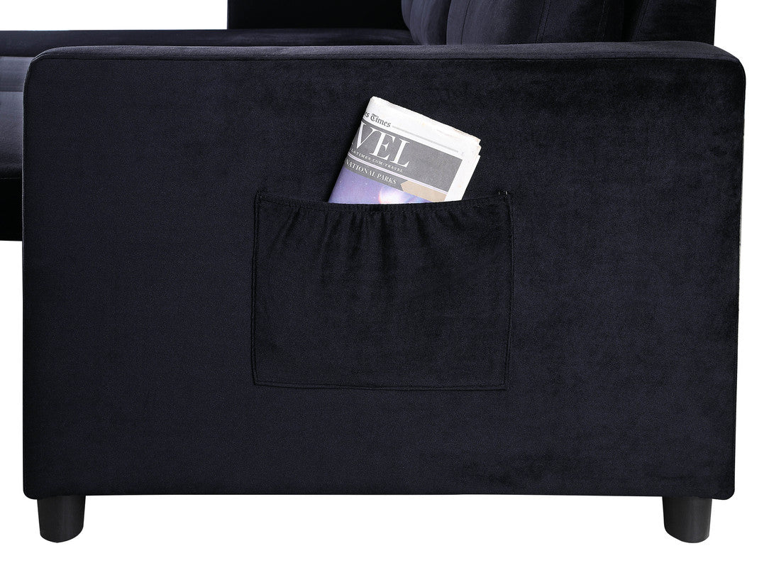 Black velvet sectional sofa with convenient side pocket holding a magazine