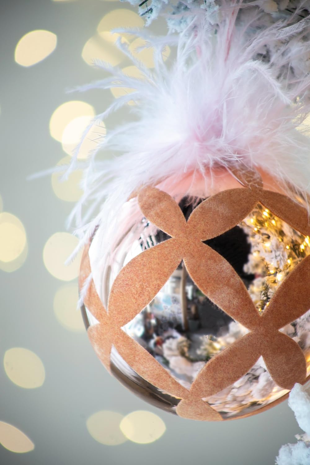 Rose gold geometric Christmas ornament with soft white feather accents