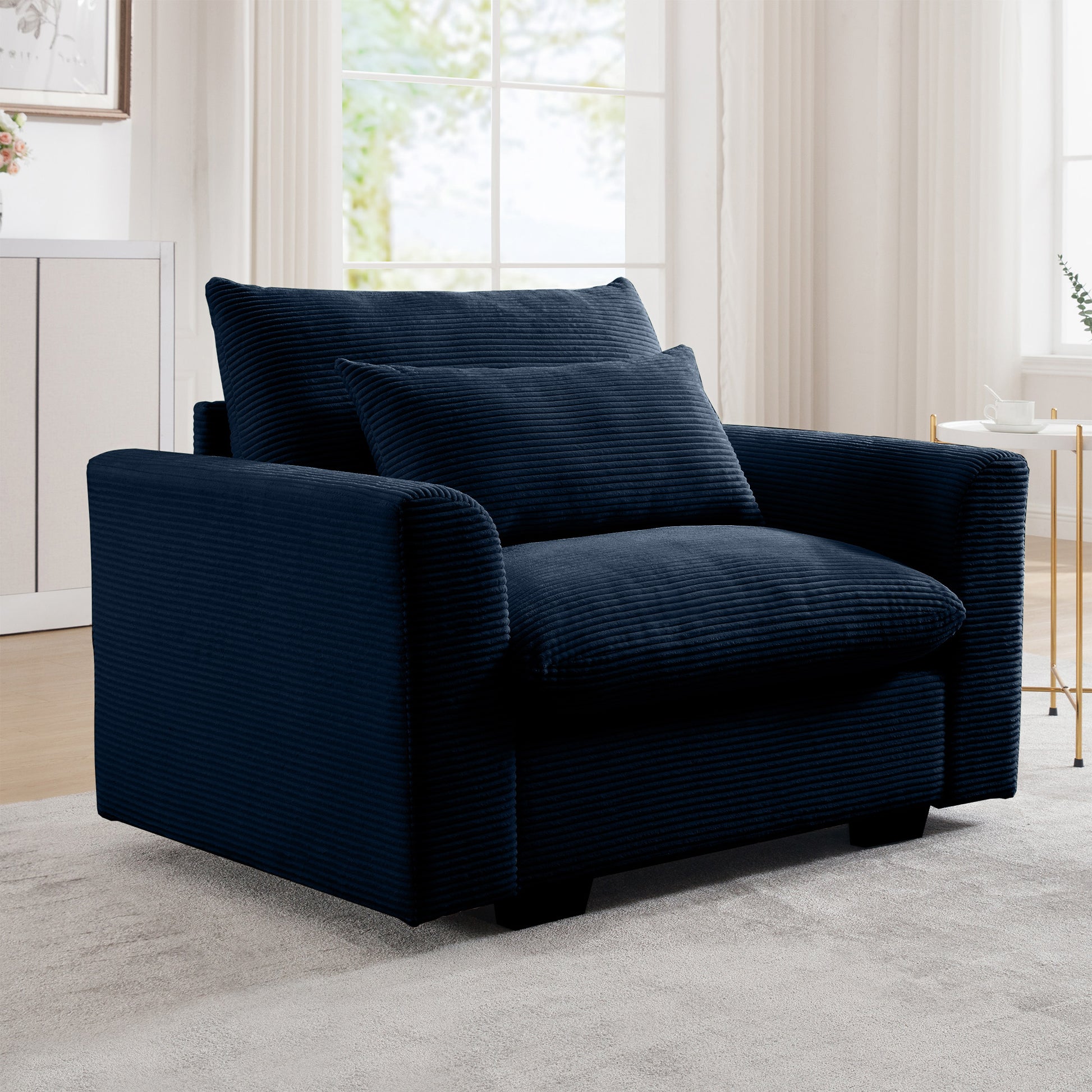 Navy blue corduroy accent chair with plush cushions and a textured fabric finish