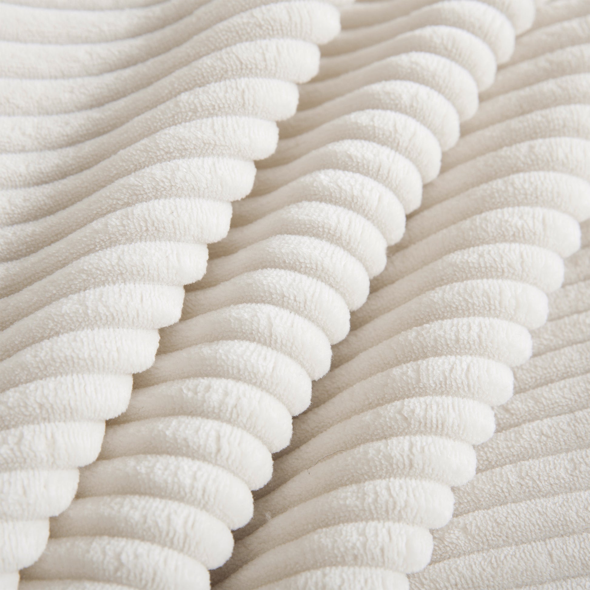Cream corduroy fabric texture closeup showing plush ribbed lines