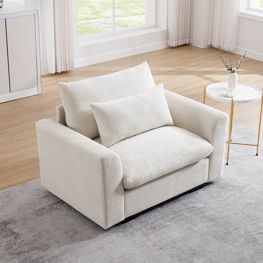 Cream corduroy armchair with plush seat and back cushions and a throw pillow