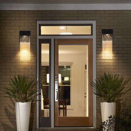 Modern outdoor wall sconce with textured glass and warm illumination by front door