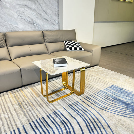 Modern taupe leather sectional sofa with a checkered pillow and side table