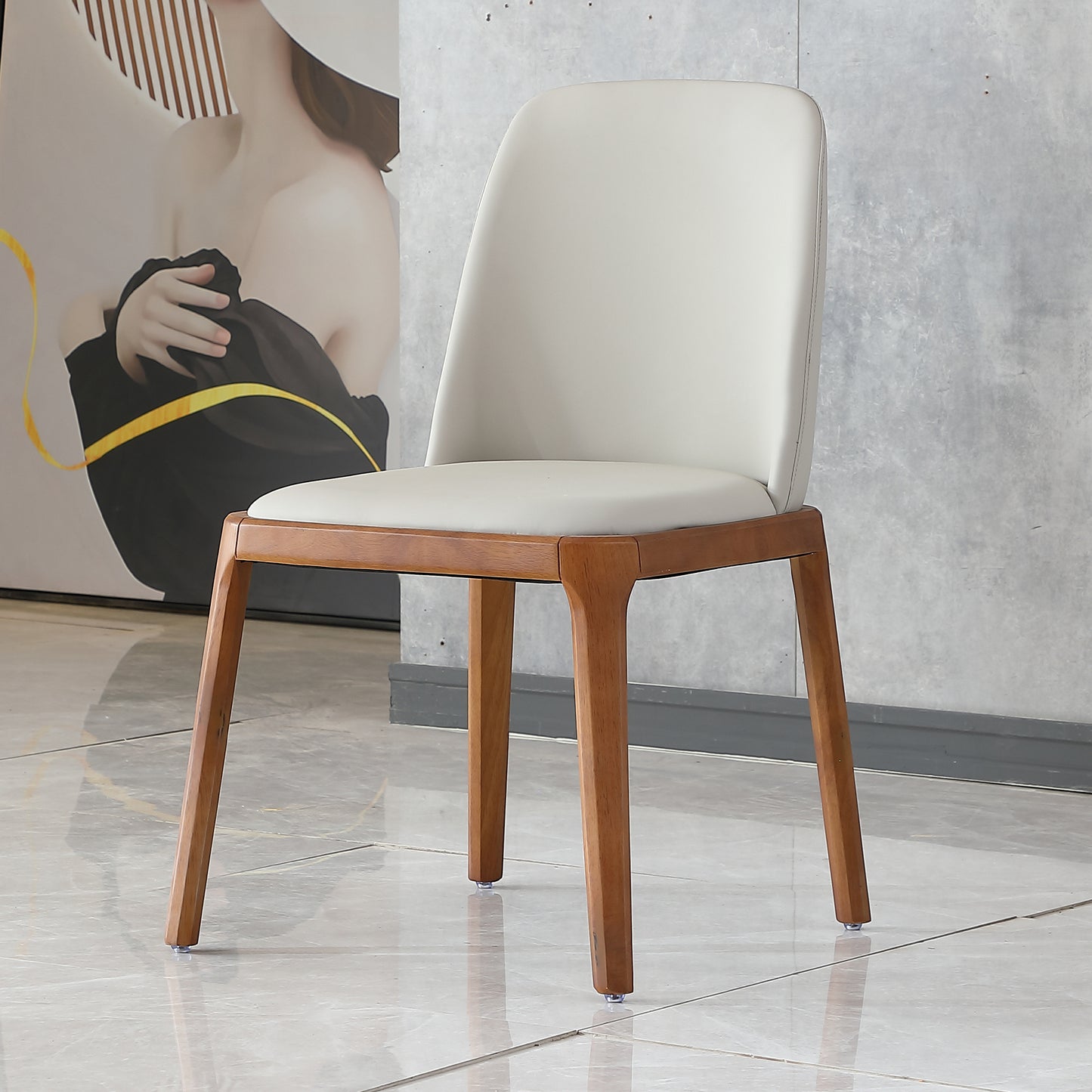 Modern dining chair with a light grey padded seat and back and natural wood legs