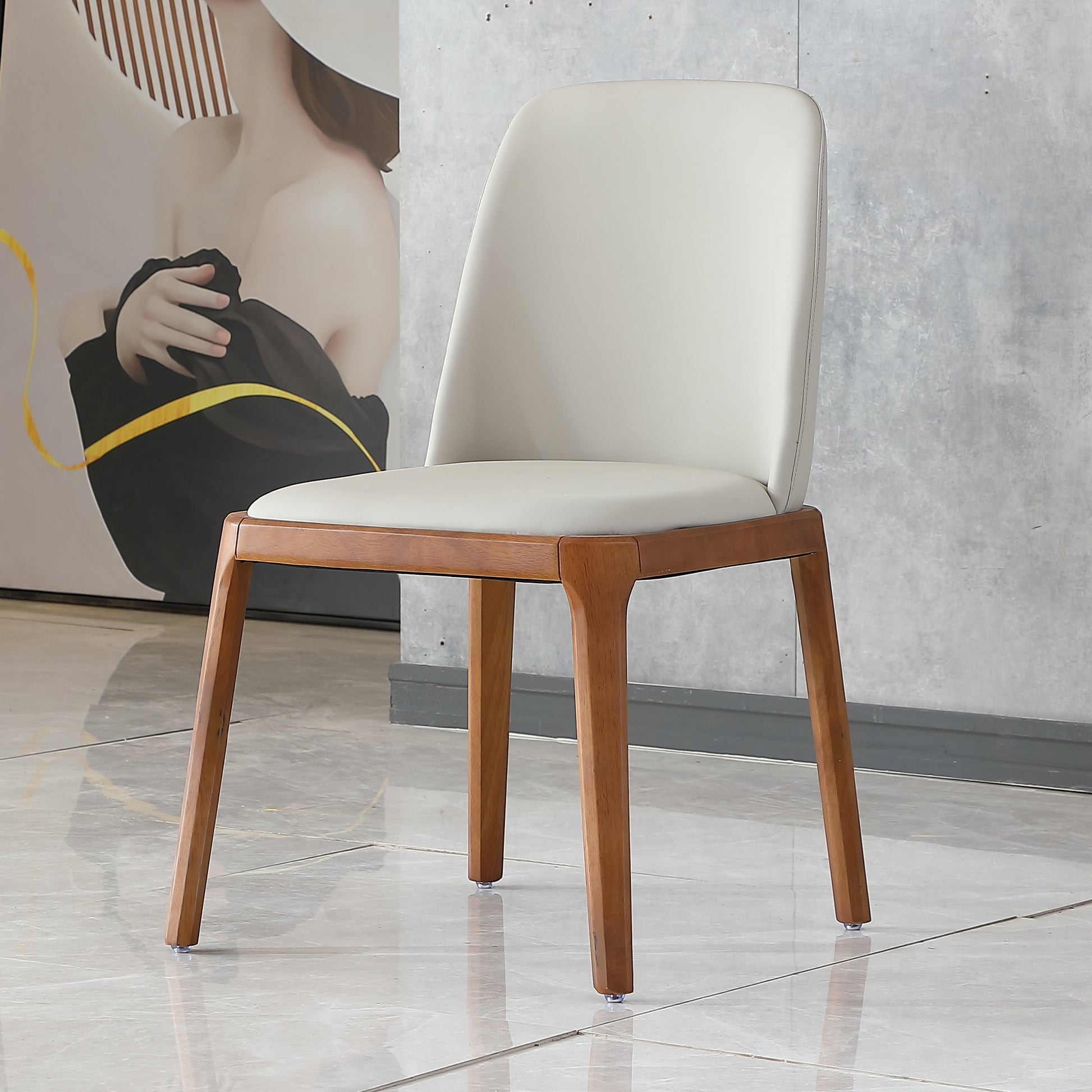 Modern dining chair with a light grey padded seat and back and natural wood legs