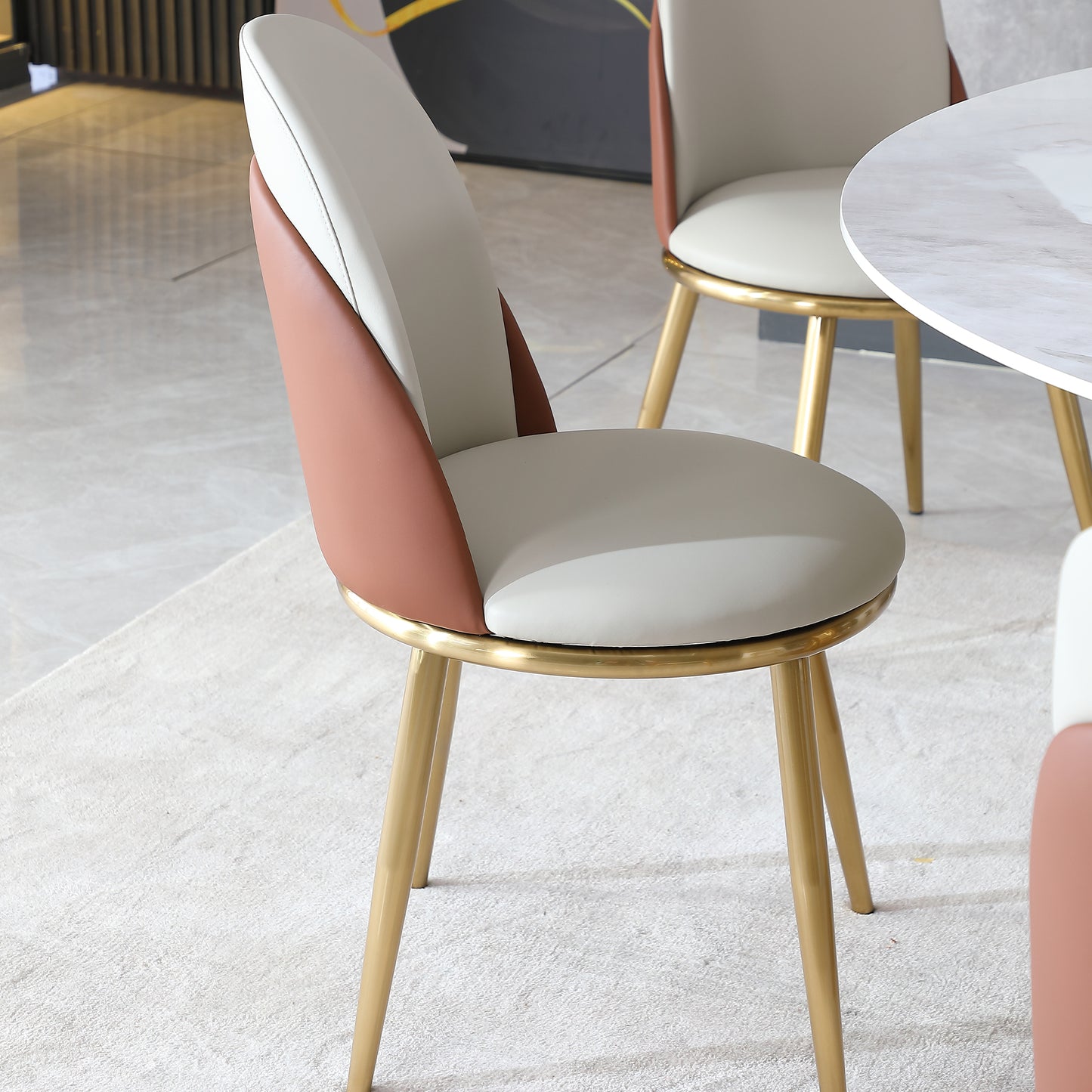 Modern beige and terracotta leather accent chair with gold legs