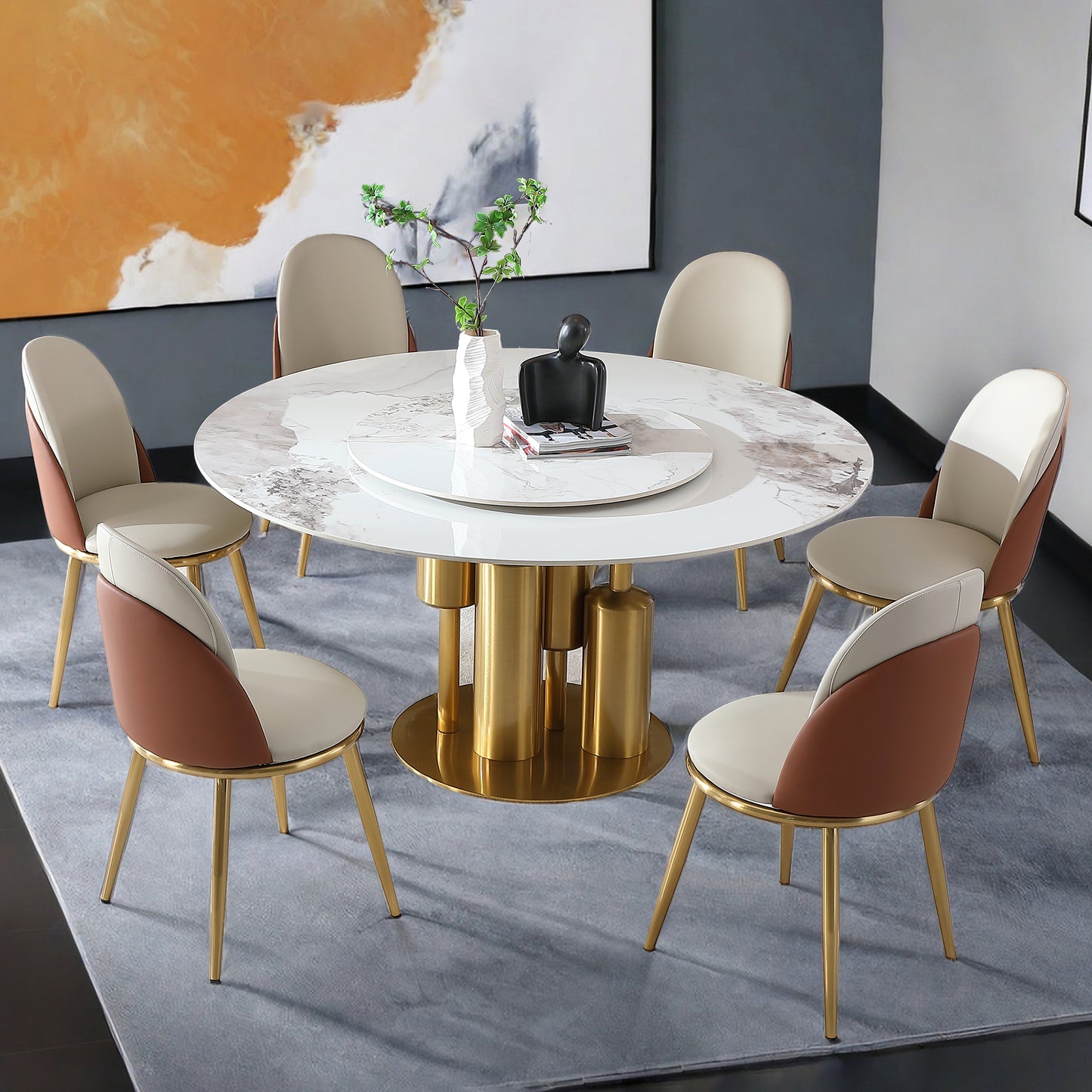 Round marble dining table with gold base and tan and cream upholstered chairs
