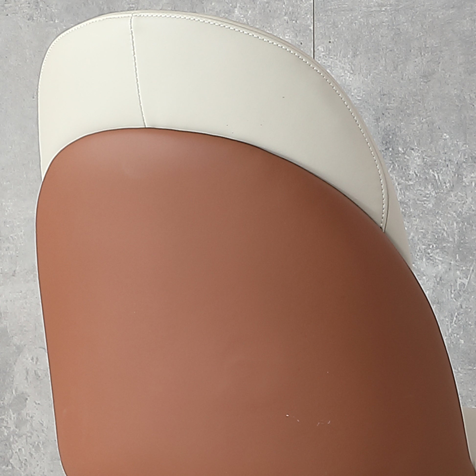 Twotone upholstered accent chair with cream and rust faux leather seats