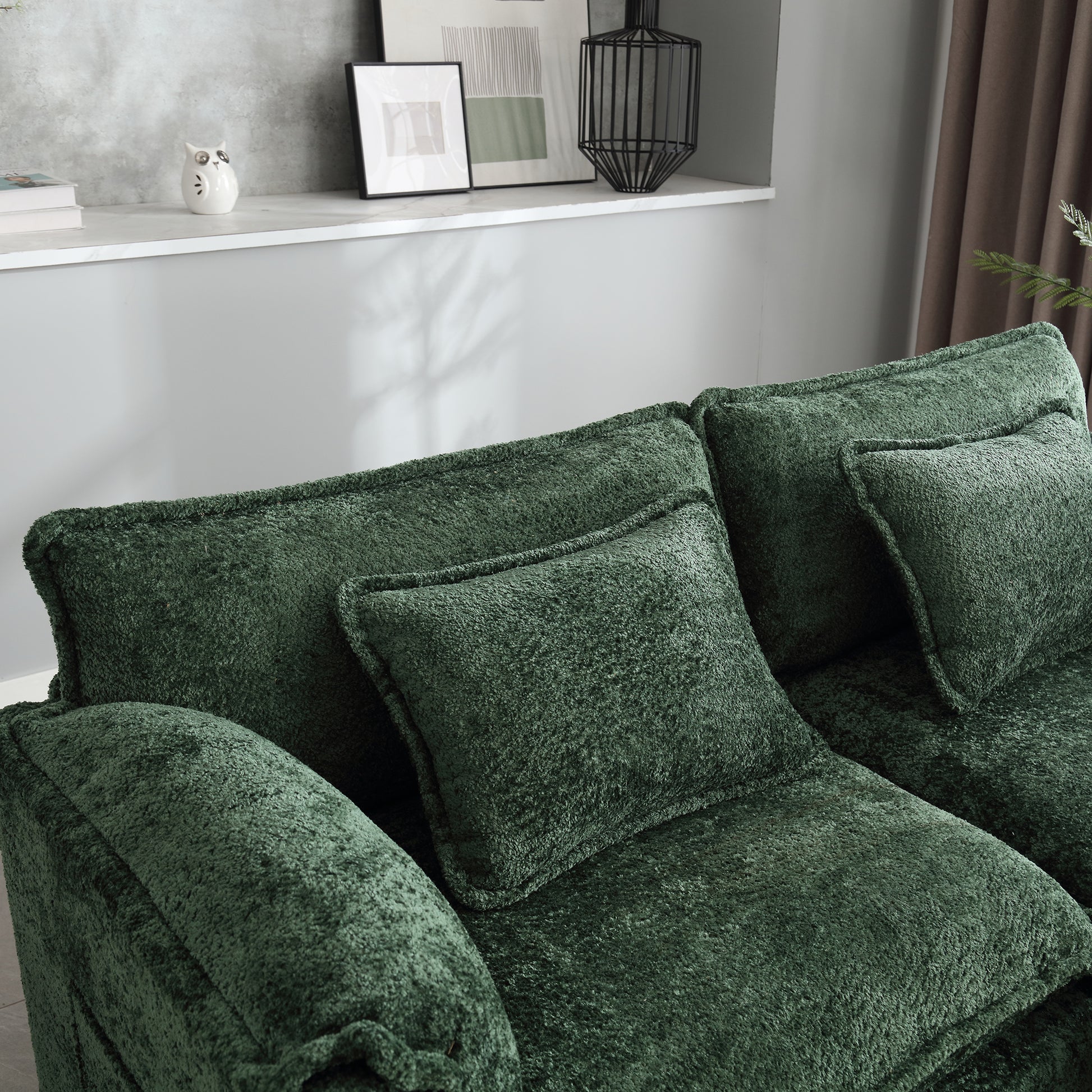 Plush dark green velvet sofa with deep seat cushions and accent pillows for ultimate comfort