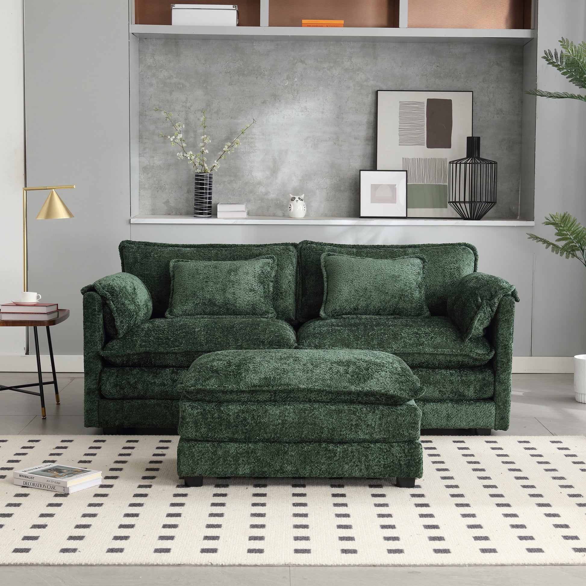 Plush emerald green velvet sofa with matching ottoman and accent pillows