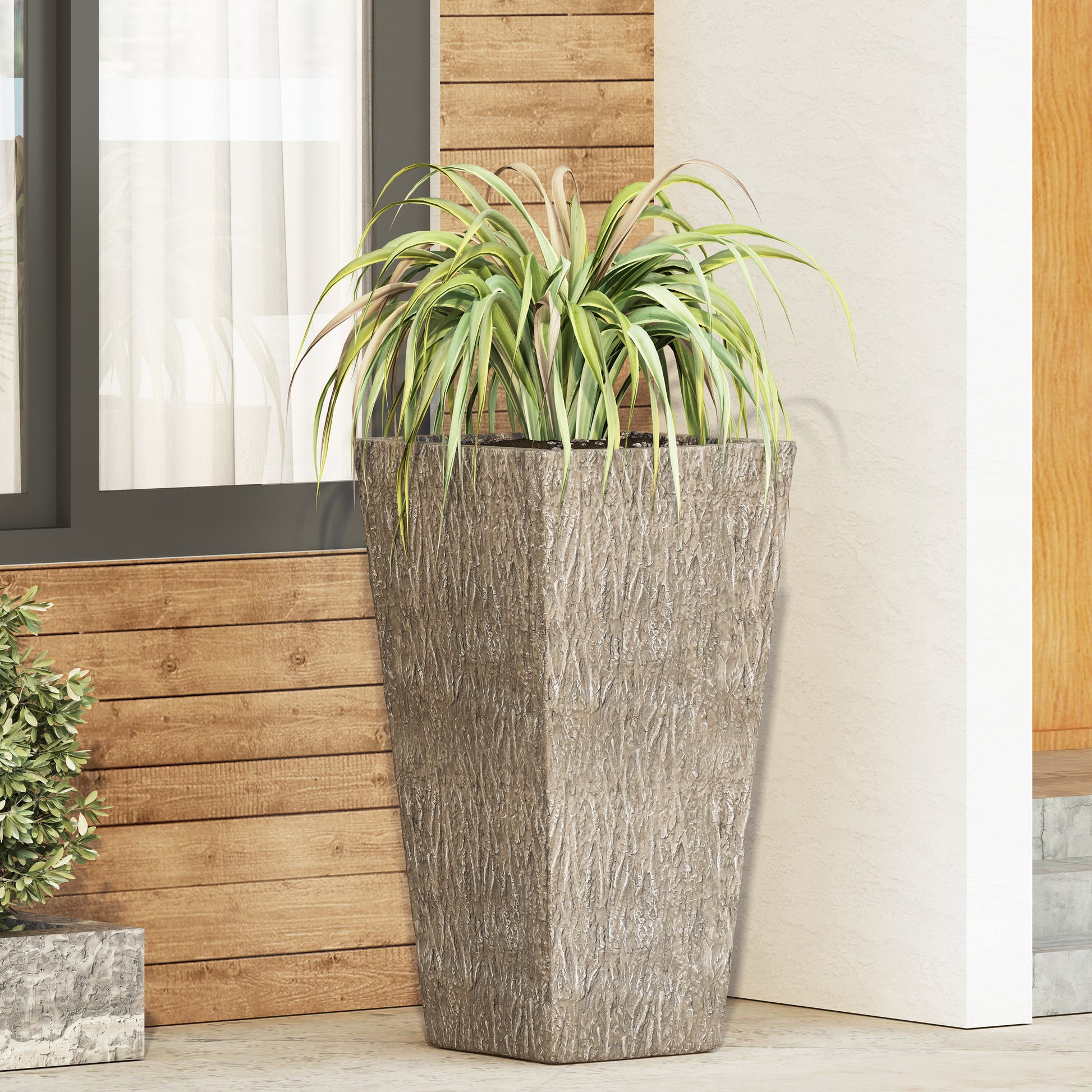Tall stone planter with textured bark finish ideal for large outdoor plants