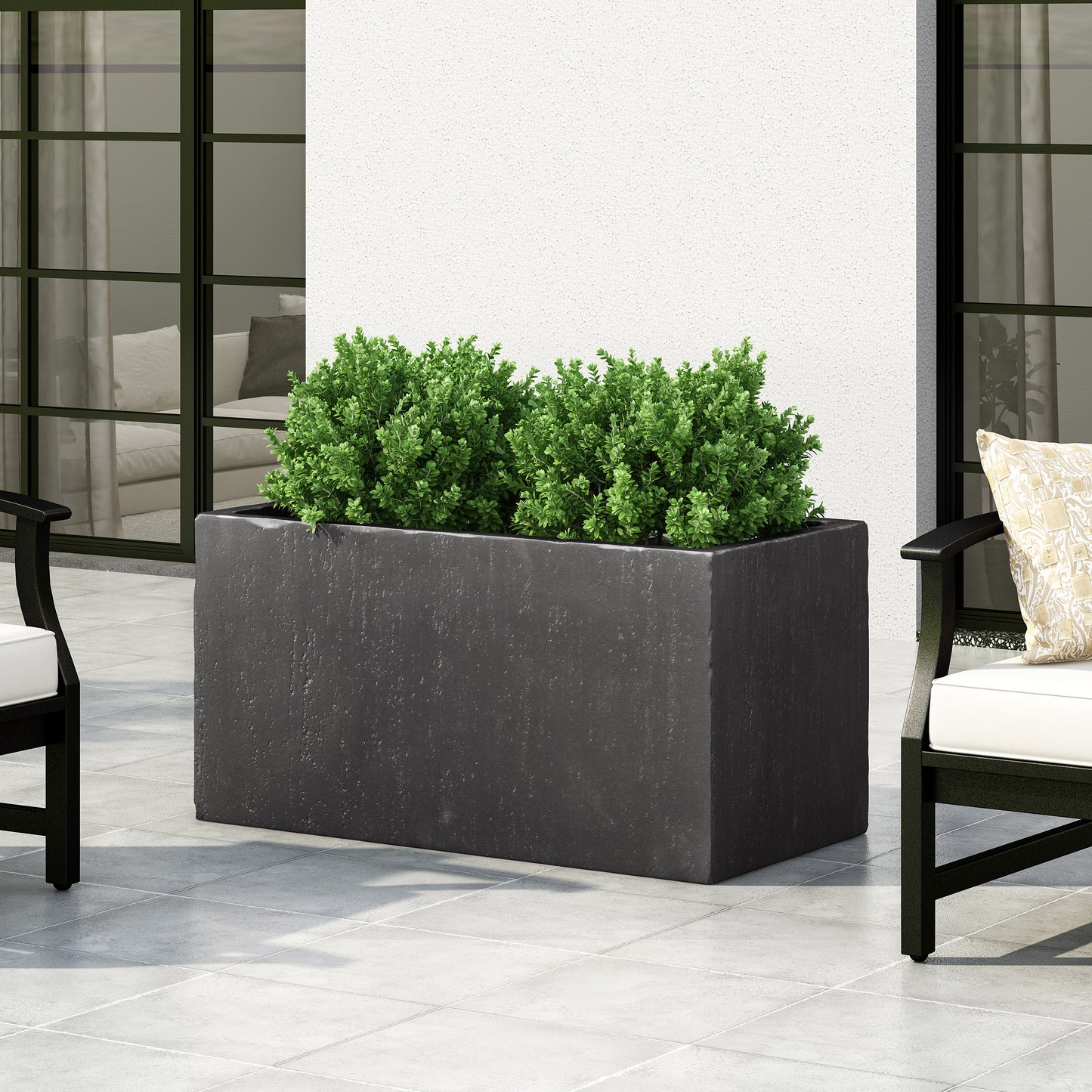 Dark grey rectangular concrete planter with green foliage and outdoor seating
