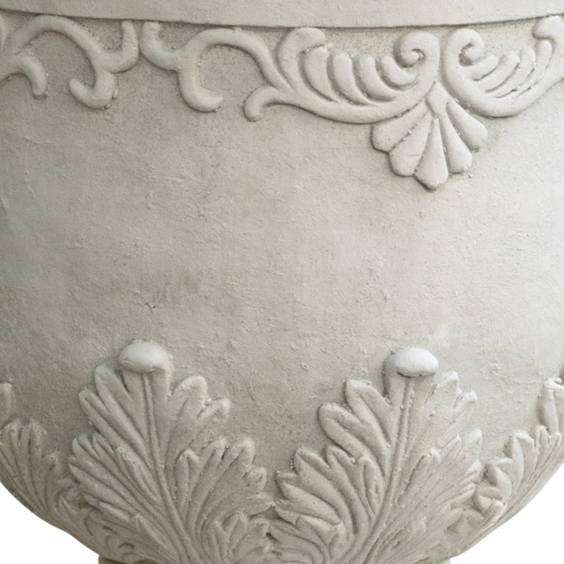 Textured grey ceramic planter with ornate scrollwork and leaf motifs for outdoor gardens