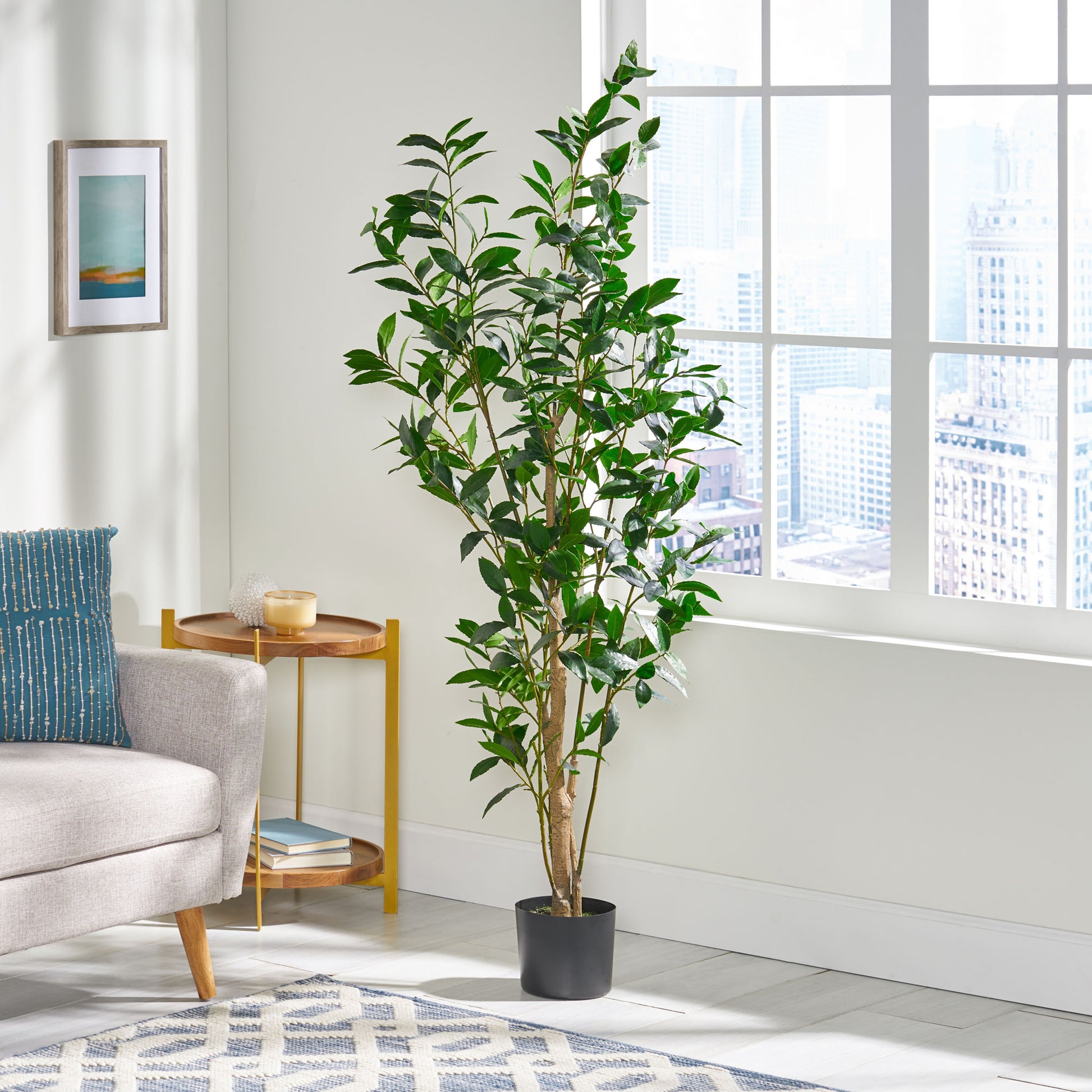 Tall artificial bay tree with lush green leaves in a simple black pot