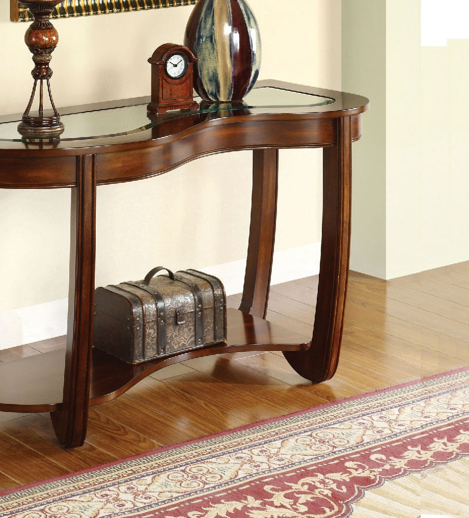 Curved mahogany console table with glass top featuring decorative trunk accent