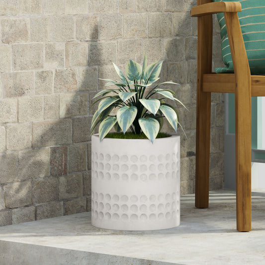 White cylindrical planter with embossed circular pattern ideal for modern outdoor decor