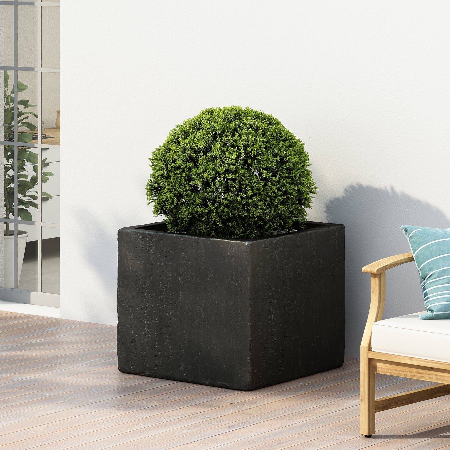 Modern dark gray square planter with lush green rounded shrub