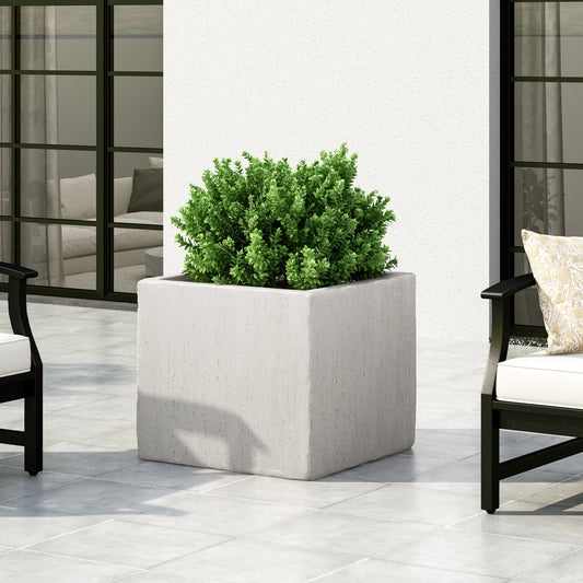 Modern large square concrete planter with a dense green shrub for outdoor decor