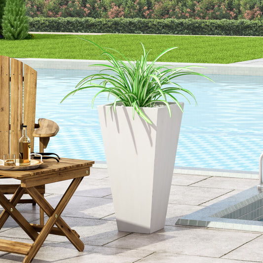 Tall tapered white planter with green and white striped spider plant by poolside