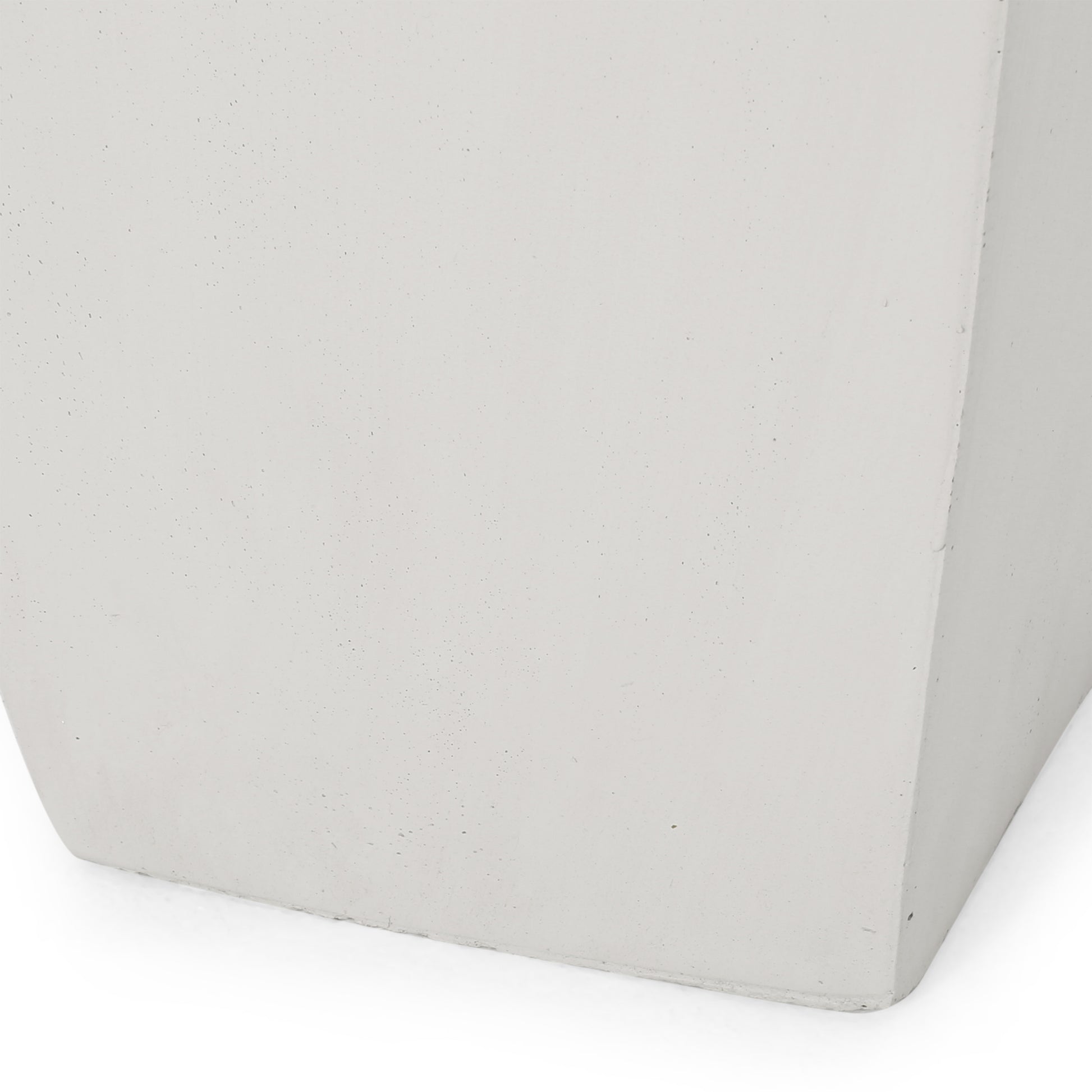 Closeup of a light gray textured concrete planter base