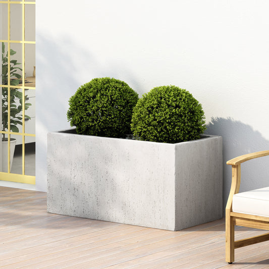 Rectangular grey concrete planter with two lush green spherical shrubs modern outdoor garden decor