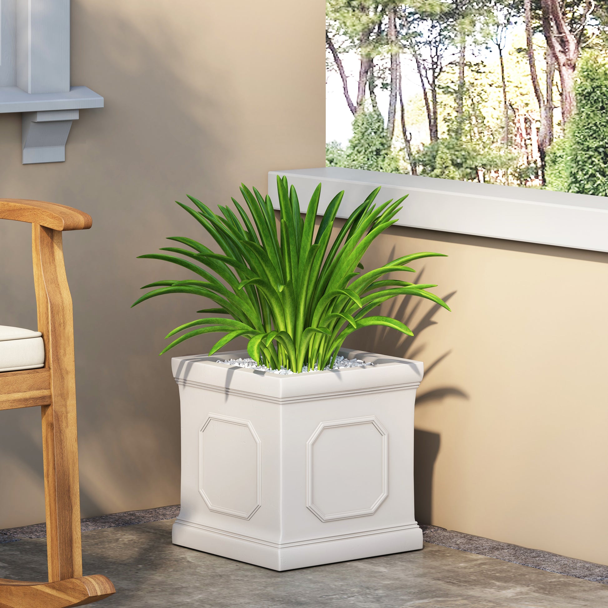 Tall white decorative planter with ornate detailing and lush green foliage