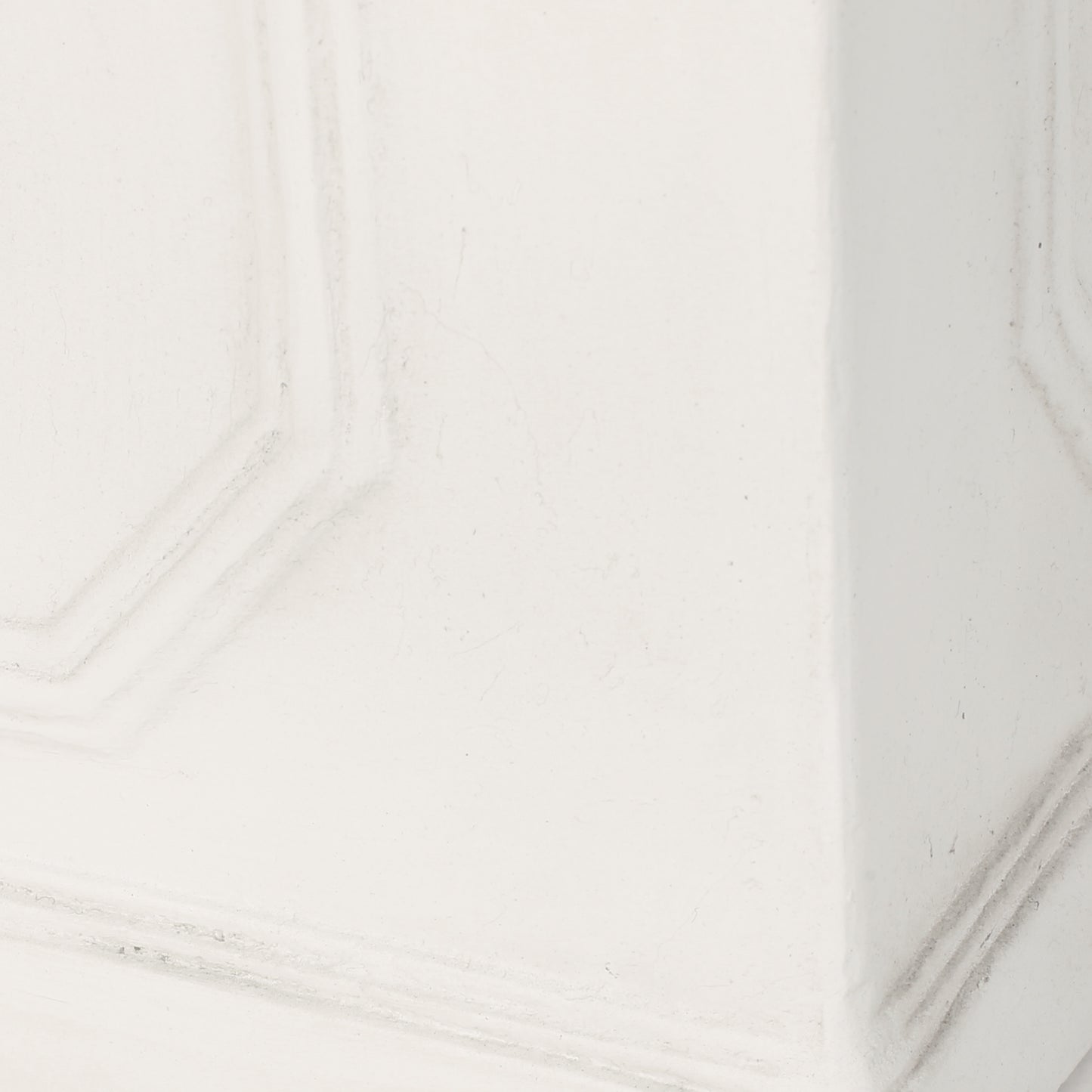 Close up of white textured wallpaper with subtle geometric pattern detail