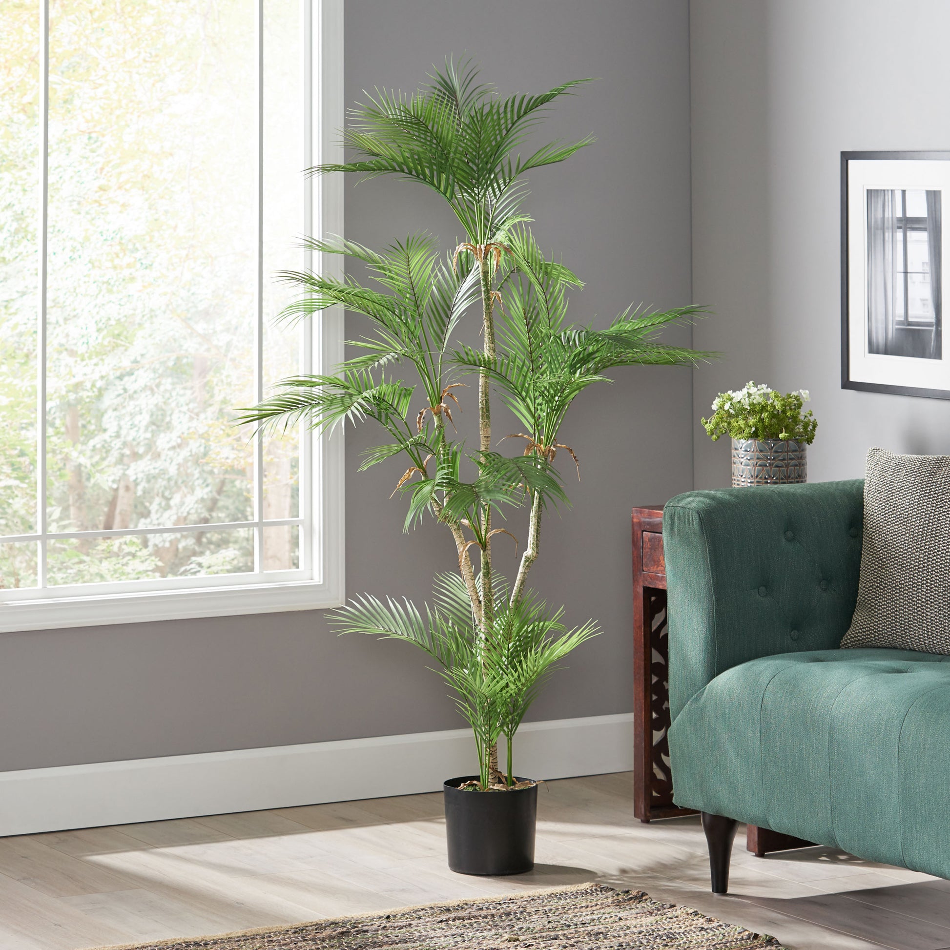 Tall artificial Areca palm with lush green fronds in a black planter