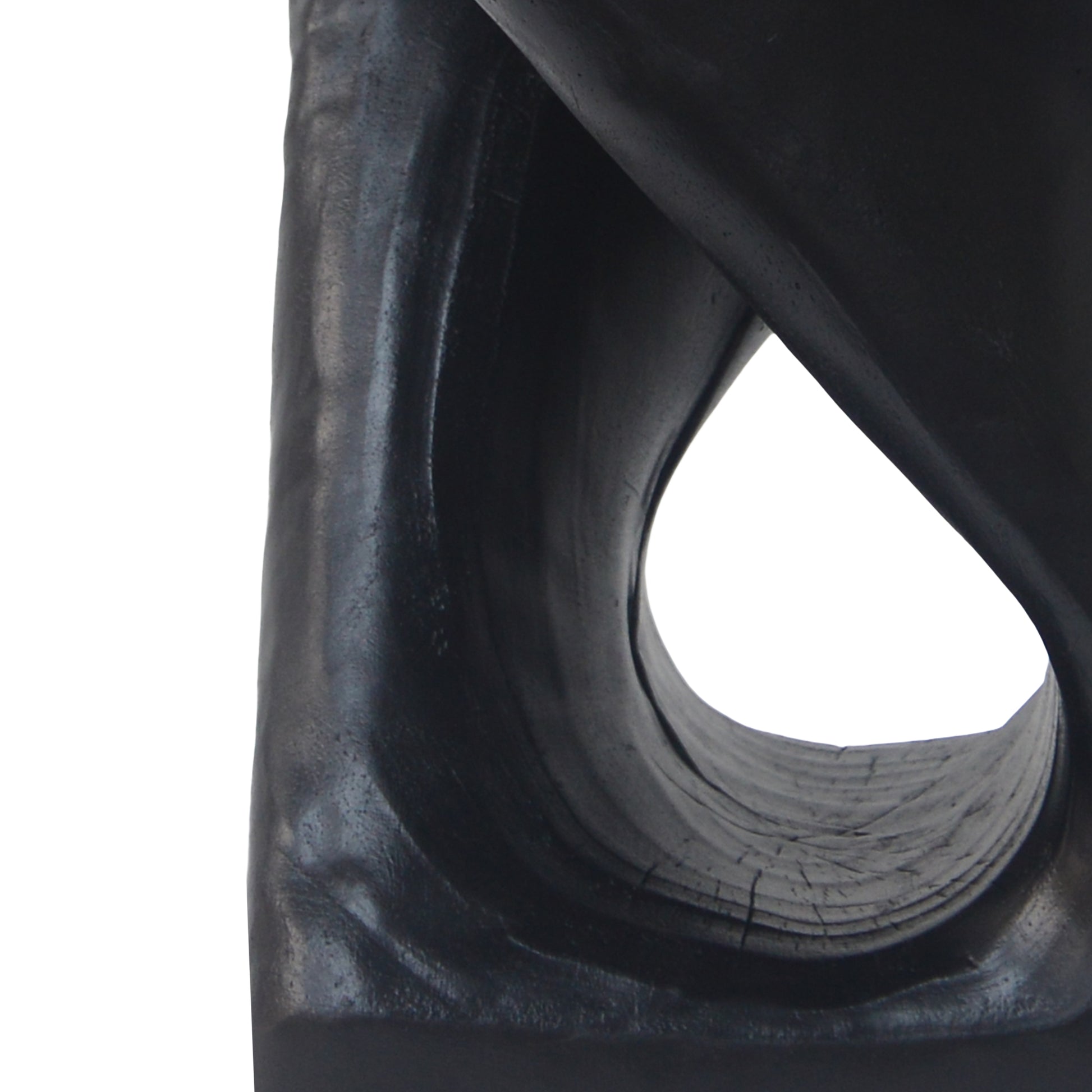 Black abstract wooden sculpture with organic curves and carved texture