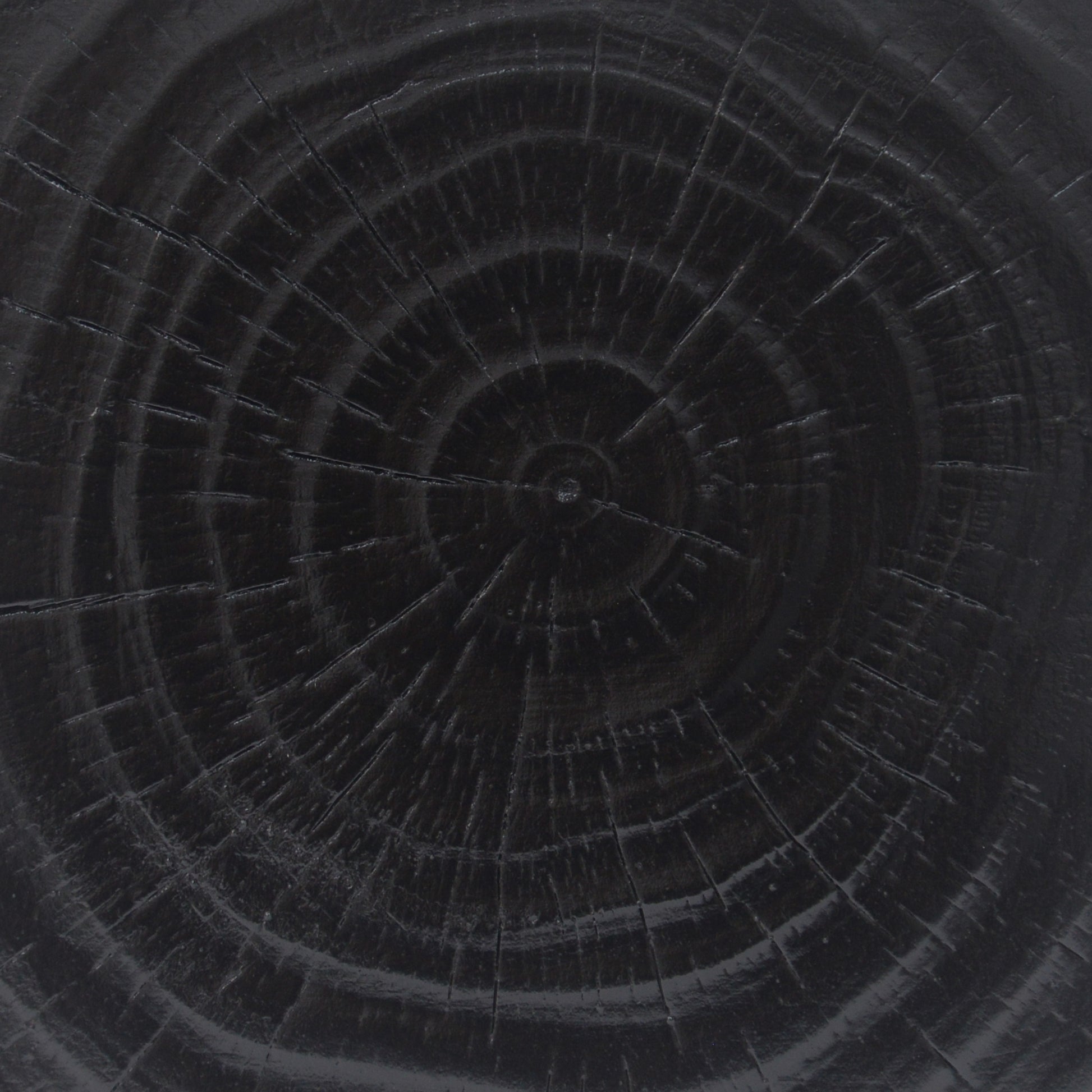 Dark wood grain texture with visible growth rings and subtle cracks