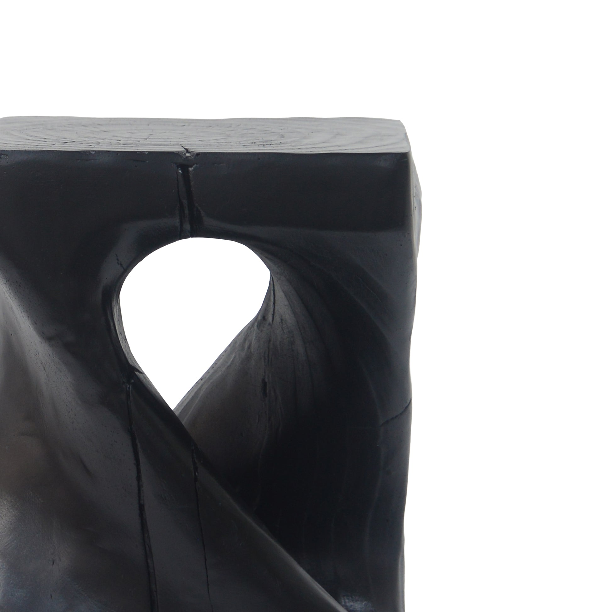 Black carved wood accent stool with organic cutout detail