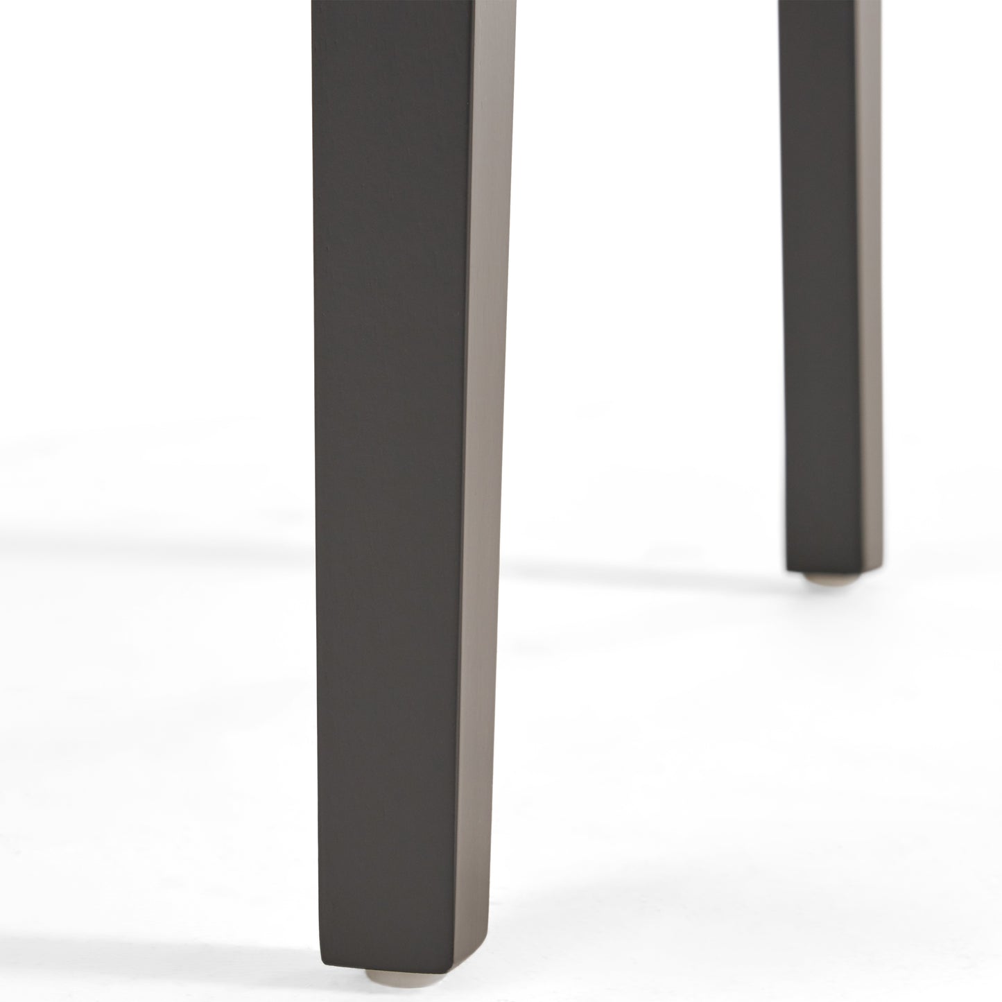Closeup of dark gray metal dining table legs with clean lines