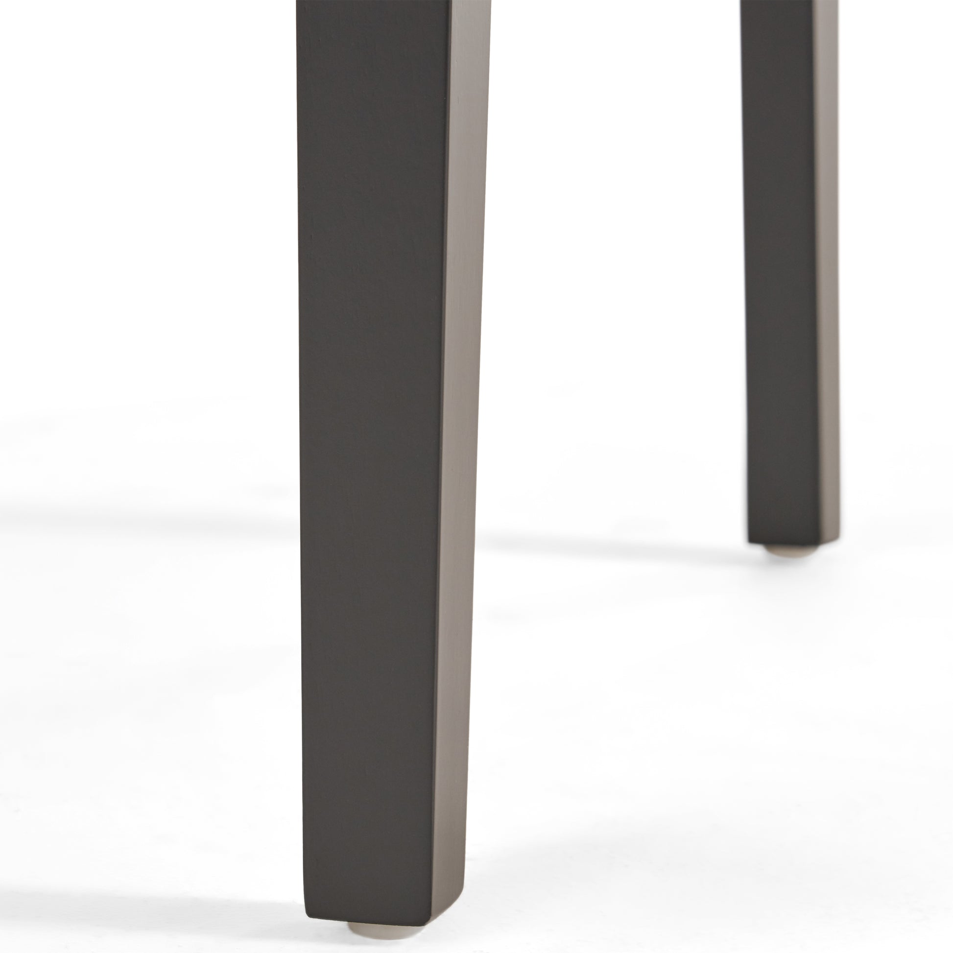 Closeup of dark gray metal dining table legs with clean lines