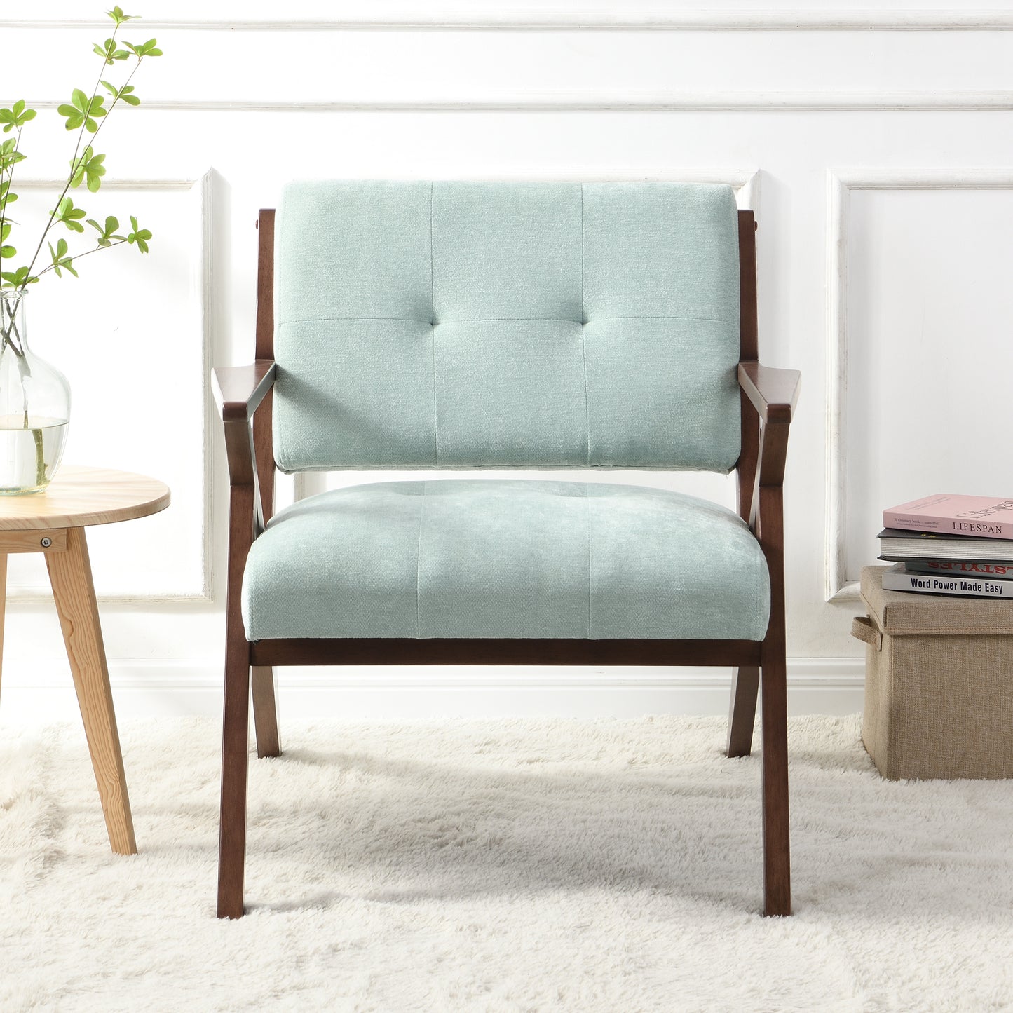 Light teal upholstered accent chair with tufted back and wooden frame