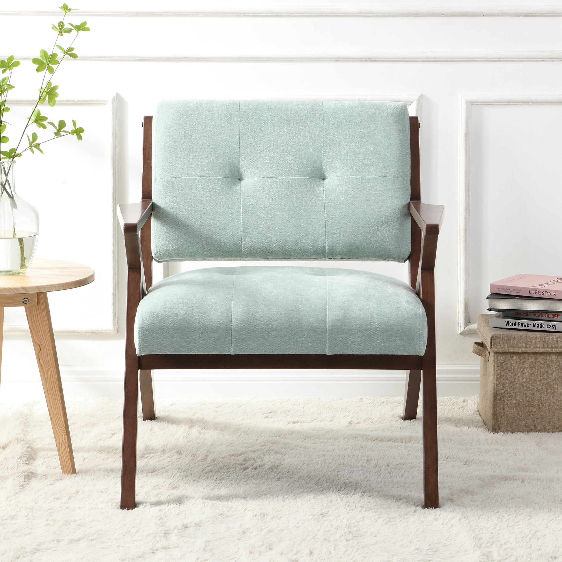 Light teal upholstered accent chair with tufted back and wooden frame