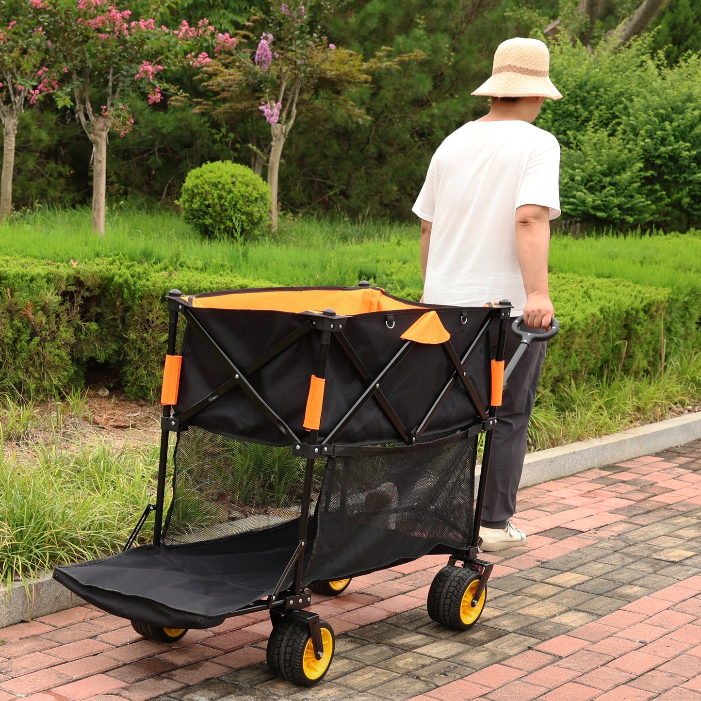 Black folding wagon with orange interior ideal for camping and outdoor use