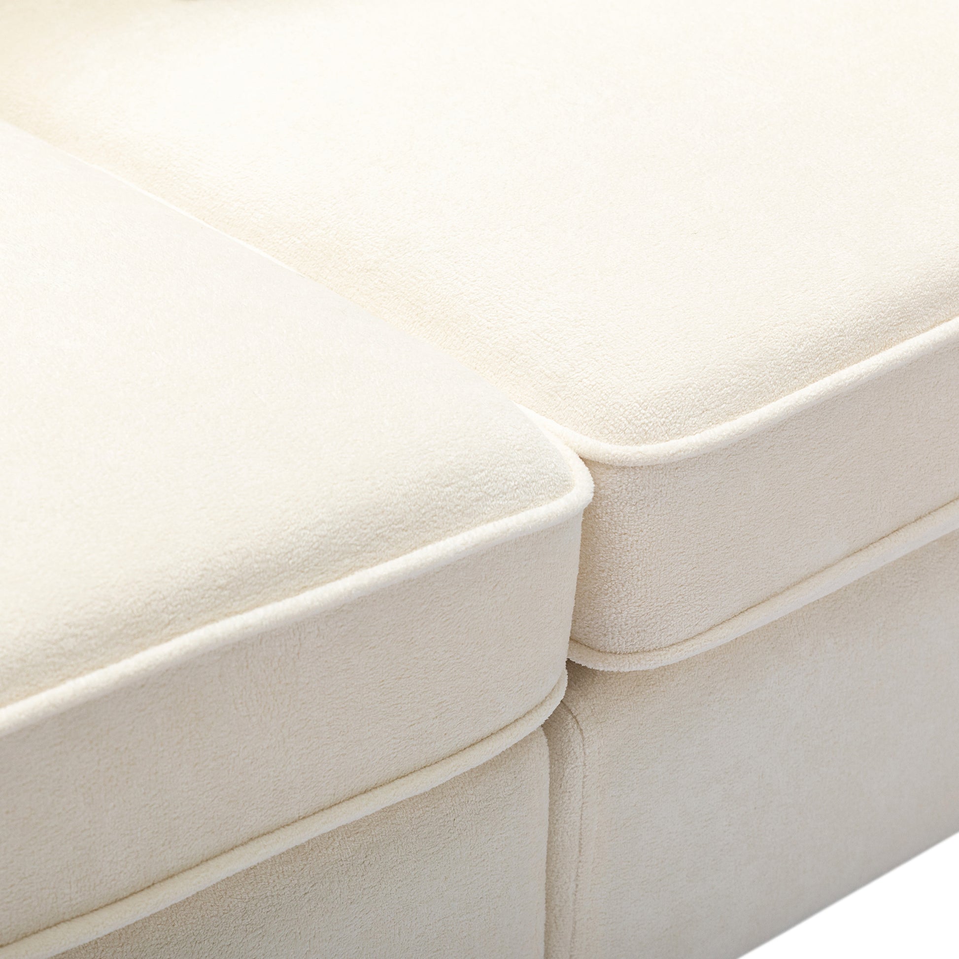 Cream boucle fabric sofa cushions with white piping detail