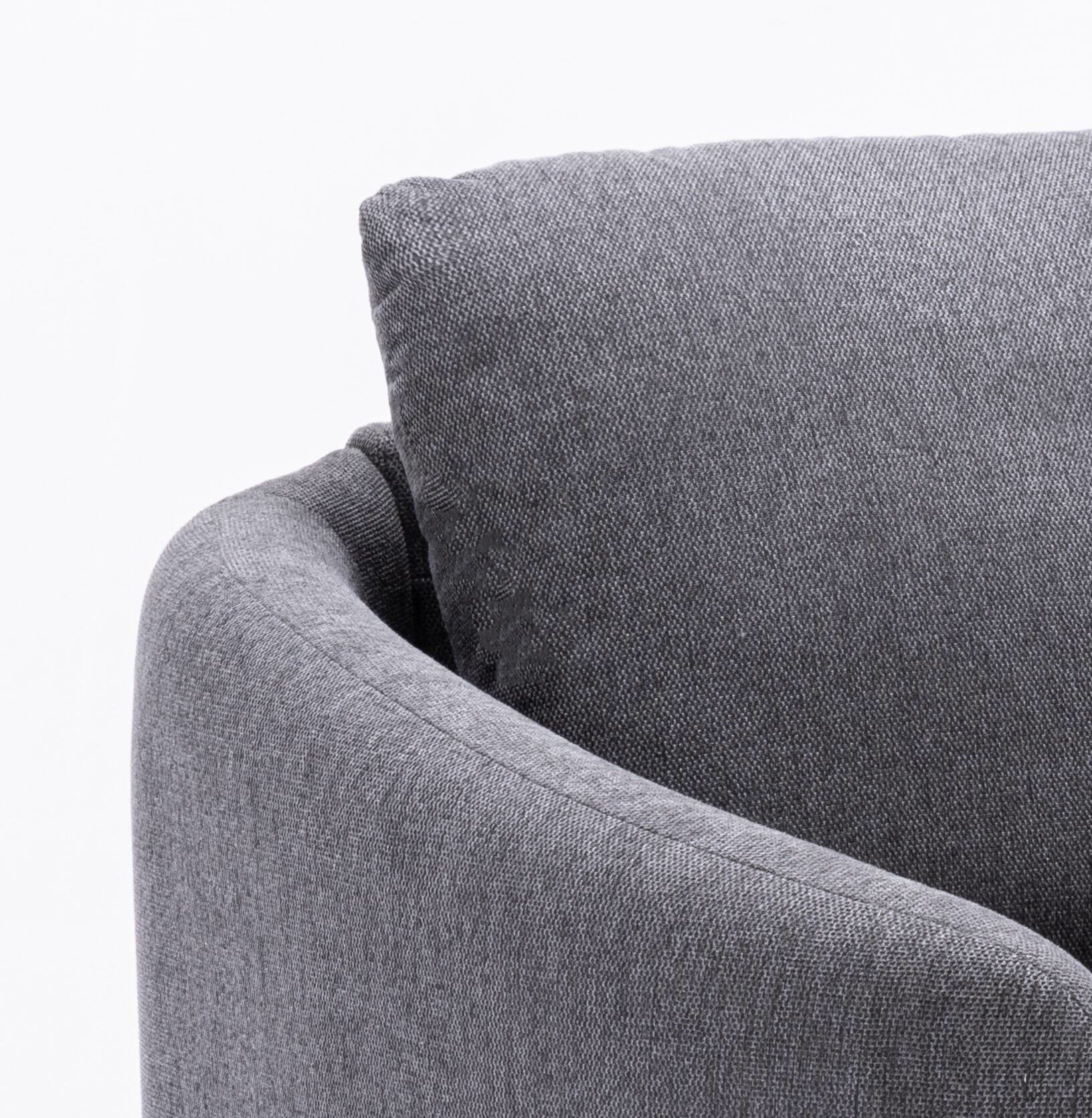 Closeup of a textured grey fabric upholstered armchair showcasing its soft material
