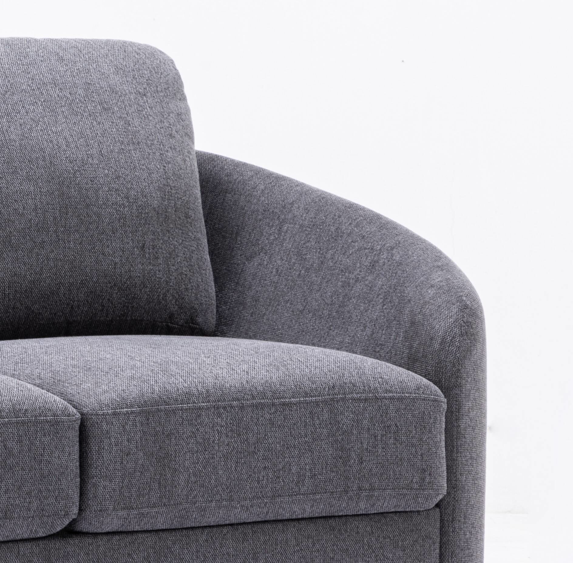 Closeup of a textured grey fabric sofa arm and cushion showcasing soft modern design