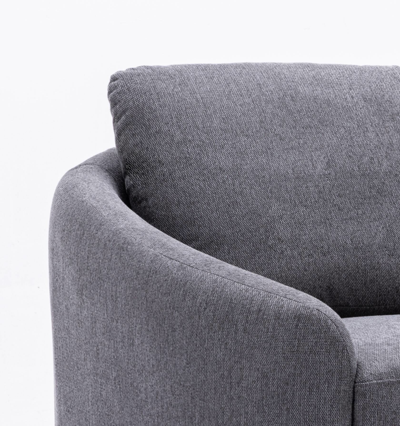Closeup of a plush grey fabric armchair with a comfortable textured weave