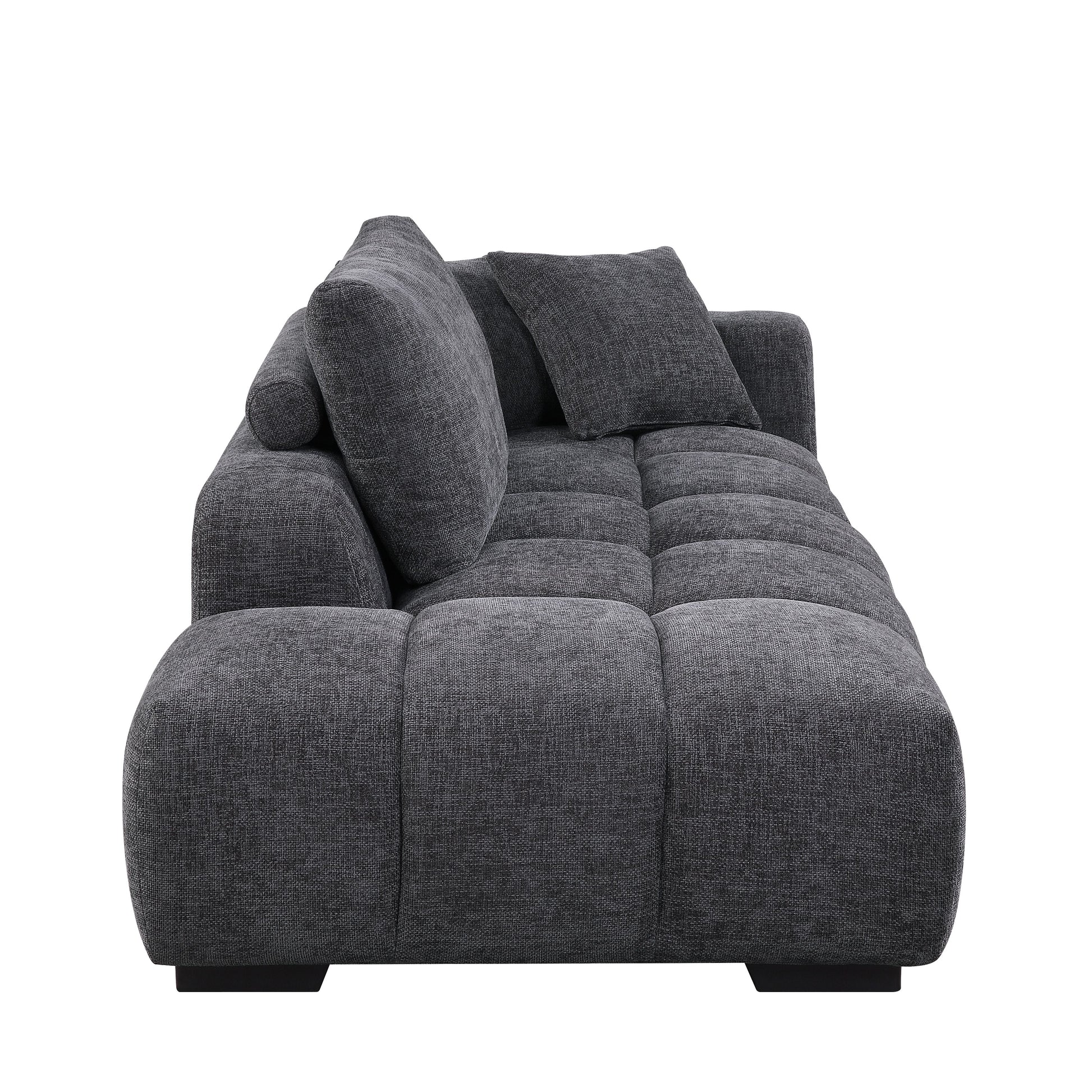 Plush grey fabric sectional sofa with tufted seat cushions and loose back pillows